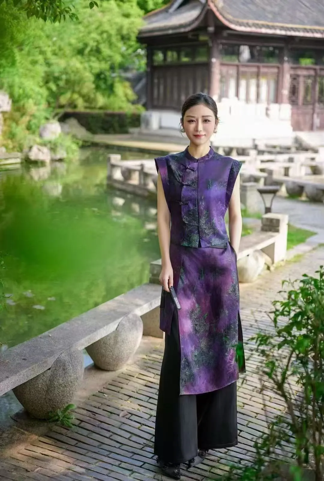 Model in a purple Chinese-style outfit walking through a garden