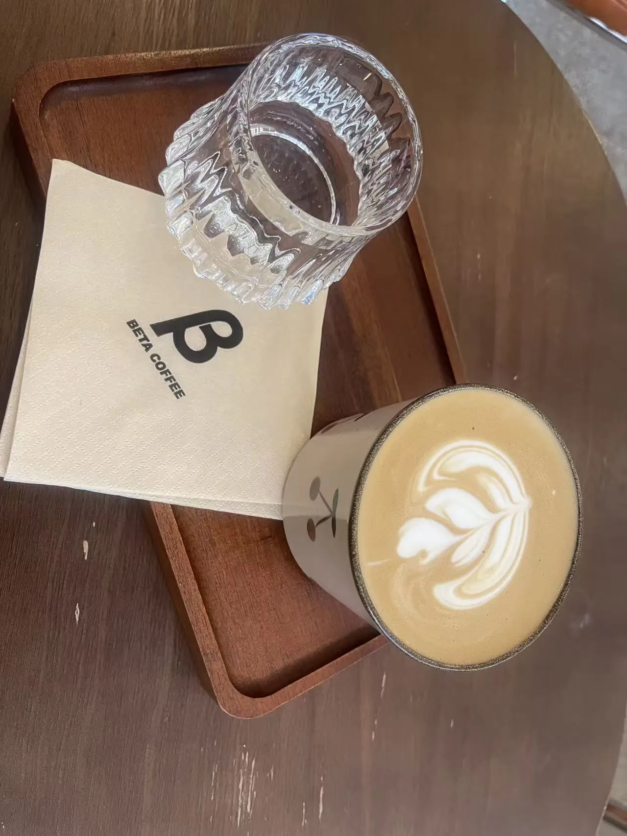 Coffee with latte art on a wooden table