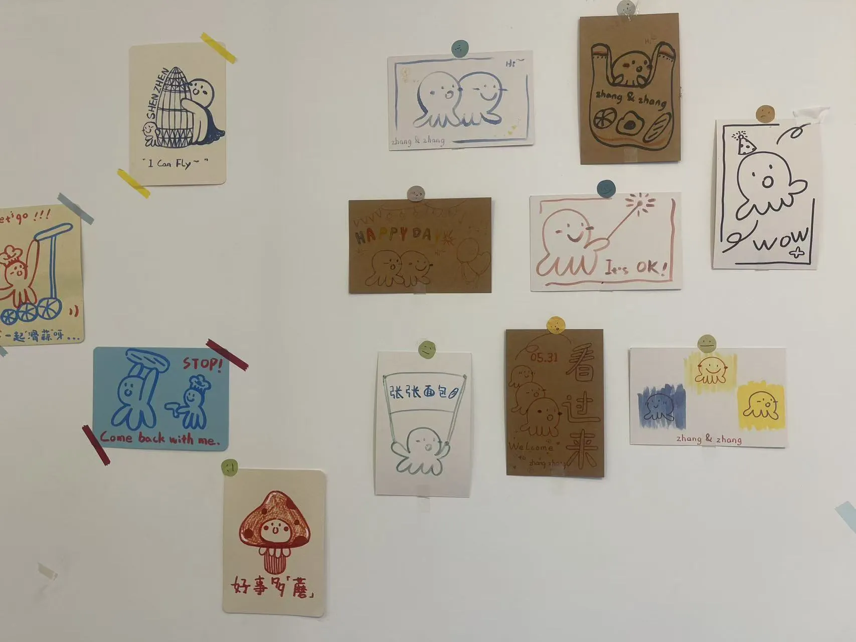A bakery wall filled with taped hand-drawn characters and notes